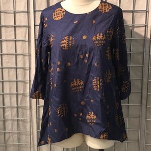 Rayon 3/4 sleeve a-line tunic w handkerchief hem. Keyhole back w embroidery